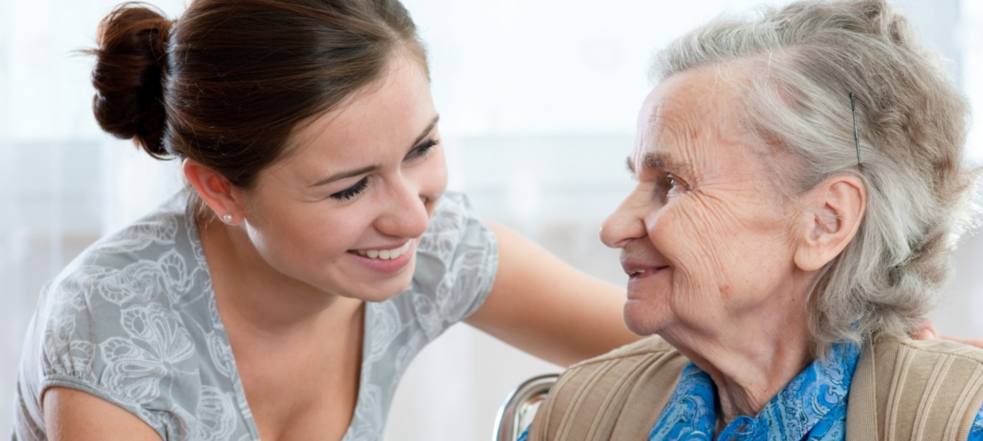 a caregiver and a senior woman talking