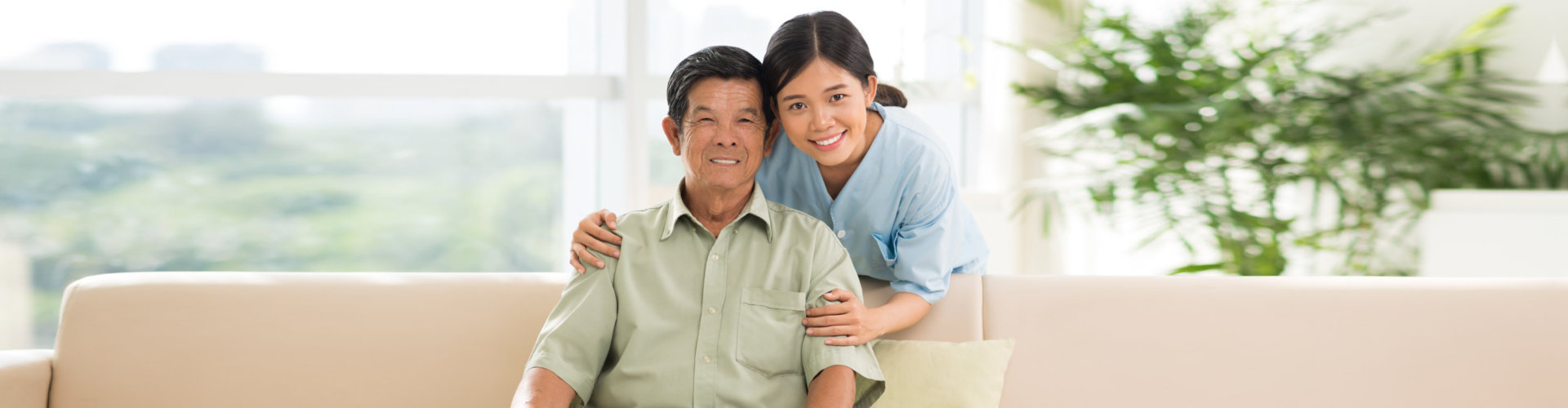 a caregiver and a senior man smiling